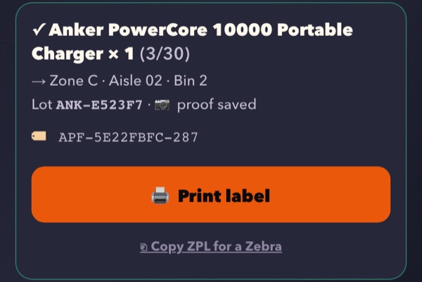 A received unit in DOS: the item name, its bin by zone, aisle and bin number, a lot number, its unit barcode and a Print label button.