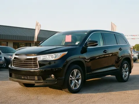 A black 2015 midsize SUV with a third row, on the lot. Sample photo.