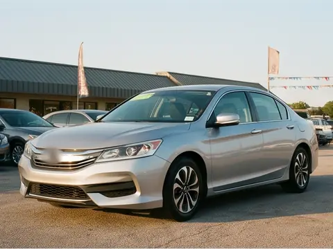 A silver 2016 midsize sedan on the lot. Sample photo.